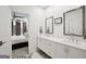 Ensuite bathroom featuring double sinks, white cabinetry, and connection to the bedroom at 1050 Stacks Ave # 1507, Atlanta, GA 30315