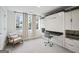 Stylish bedroom offers a murphy bed, a modern chair and built in shelving at 1050 Stacks Ave # 1507, Atlanta, GA 30315