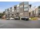 Modern townhome exterior featuring brick facade, balconies, and well-maintained landscaping against a backdrop of blue skies at 1050 Stacks Ave # 1507, Atlanta, GA 30315
