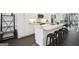 Panorama of kitchen with island and seating, white cabinets, and stainless steel appliances at 1050 Stacks Ave # 1507, Atlanta, GA 30315
