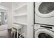 Bright laundry room features a stacked washer and dryer, shelving and cabinets at 1050 Stacks Ave # 1507, Atlanta, GA 30315