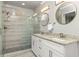 Elegant bathroom with double vanity sinks with granite counters and walk-in glass enclosed shower at 1711 Terry Mill Se Rd, Atlanta, GA 30316