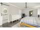 Bright bedroom with a light-colored dresser, dark floors, and a view into the attached bathroom and office space at 1711 Terry Mill Se Rd, Atlanta, GA 30316