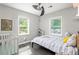 Sunlit bedroom with large windows, a ceiling fan, and hardwood flooring at 1711 Terry Mill Se Rd, Atlanta, GA 30316