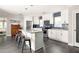 Bright kitchen featuring white cabinetry, stainless steel appliances, granite countertops, and a stylish island with seating at 1711 Terry Mill Se Rd, Atlanta, GA 30316