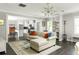Open-concept living area with modern lighting, neutral decor, and hardwood floors seamlessly connecting to the kitchen at 1711 Terry Mill Se Rd, Atlanta, GA 30316