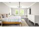 Serene main bedroom with natural light, a sliding barn door, and neutral decor, perfect for relaxation at 1711 Terry Mill Se Rd, Atlanta, GA 30316