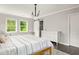 Comfortable main bedroom with natural light, wood floors, and a sliding barn door to the bathroom at 1711 Terry Mill Se Rd, Atlanta, GA 30316