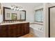 Bathroom featuring large framed mirror, double sink vanity, and soaking tub at 2267 Howell Farms Trl, Acworth, GA 30101