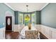 Elegant dining room with hardwood floors, bay windows, and stylish chandelier at 2267 Howell Farms Trl, Acworth, GA 30101