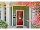 Close-up of a welcoming red front door with decorative glass and a cozy doormat at 2267 Howell Farms Trl, Acworth, GA 30101