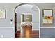 Hallway view with archway leading into a dining room with wood floors at 2267 Howell Farms Trl, Acworth, GA 30101