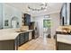 Open kitchen featuring stainless steel appliances, gray cabinets and view into a brightly lit breakfast nook at 2267 Howell Farms Trl, Acworth, GA 30101