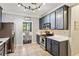 Spacious kitchen featuring stainless steel appliances, gray cabinets and a view to the breakfast nook at 2267 Howell Farms Trl, Acworth, GA 30101