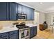 Well-equipped kitchen with stainless steel appliances, gray cabinets, and tile backsplash at 2267 Howell Farms Trl, Acworth, GA 30101