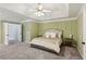 Large primary bedroom with carpet, tray ceiling, and neutral décor at 2267 Howell Farms Trl, Acworth, GA 30101