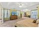 Spacious carpeted primary bedroom featuring tray ceiling and natural light at 2267 Howell Farms Trl, Acworth, GA 30101