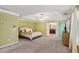 Spacious primary bedroom featuring carpet, tray ceiling, and doorway to ensuite bath at 2267 Howell Farms Trl, Acworth, GA 30101