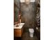 Small powder room with modern sink, dark tile and elegant fixtures at 2469 River Oak Dr, Decatur, GA 30033