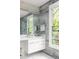Bright bathroom with stone tile, modern vanity, vessel sink, and updated fixtures at 2469 River Oak Dr, Decatur, GA 30033