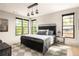 Well-lit bedroom with large windows, hardwood floors, metal bed frame and stylish lighting at 2469 River Oak Dr, Decatur, GA 30033