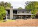 Exterior view of home with a large backyard, covered patio and balcony at 2469 River Oak Dr, Decatur, GA 30033