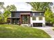 Beautiful two-story modern home with a lush green lawn and an attached garage at 2469 River Oak Dr, Decatur, GA 30033