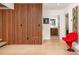 Hallway with accent wall, light hardwood floors, and doorway views to bathroom at 2469 River Oak Dr, Decatur, GA 30033