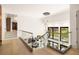 Hallway with glass railing overlooking the living room, and modern light fixtures at 2469 River Oak Dr, Decatur, GA 30033