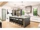 Bright kitchen with marble island, counter seating, stainless steel appliances, and designer lighting at 2469 River Oak Dr, Decatur, GA 30033