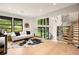 Open-concept living room with floor-to-ceiling windows, white sofa, and wood floors at 2469 River Oak Dr, Decatur, GA 30033