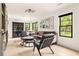 Spacious living room with comfortable seating, a decorative cabinet, and large windows overlooking the backyard at 2469 River Oak Dr, Decatur, GA 30033