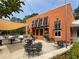 Exterior patio with multiple tables and chairs in a pleasant environment, illuminated with string lights at 2469 River Oak Dr, Decatur, GA 30033