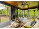 Inviting covered patio with stone fireplace, comfortable seating, and outdoor greenery at 2469 River Oak Dr, Decatur, GA 30033