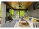 Relaxing covered patio with a stone fireplace, tv, ceiling fan, and comfortable seating at 2469 River Oak Dr, Decatur, GA 30033
