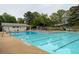 Sparkling swimming pool area featuring lounge chairs, umbrellas, and a recreational pavilion at 2469 River Oak Dr, Decatur, GA 30033