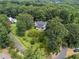 Aerial view of a meticulously landscaped home with a lush lawn, mature trees, and a winding driveway at 269 Red Gate Dr, Canton, GA 30115