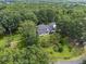 Aerial shot of a lovely home with a large yard, surrounded by mature trees and landscaping at 269 Red Gate Dr, Canton, GA 30115