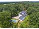 Aerial view of a charming home featuring an in-ground pool, beautiful landscaping, and a large driveway at 269 Red Gate Dr, Canton, GA 30115