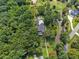 Aerial view showcasing a home with a pool, extensive landscaping, and a private setting surrounded by trees at 269 Red Gate Dr, Canton, GA 30115