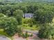 Charming home with lush landscaping, mature trees, and a winding driveway, creating a private oasis at 269 Red Gate Dr, Canton, GA 30115