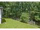 Fenced-in backyard with lush lawn and mature trees offer privacy and space for outdoor enjoyment at 269 Red Gate Dr, Canton, GA 30115