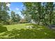 Fenced-in backyard featuring lush grass and mature trees in a tranquil setting at 269 Red Gate Dr, Canton, GA 30115