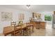 Dining area with wood table, chairs, and bright lighting with a view to the eat-in kitchen at 269 Red Gate Dr, Canton, GA 30115