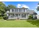 Charming two-story home with a welcoming front porch, well-manicured lawn, and garage at 269 Red Gate Dr, Canton, GA 30115