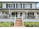Charming two-story home with a inviting white-railed porch and beautifully landscaped front yard at 269 Red Gate Dr, Canton, GA 30115