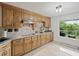 Charming kitchen with light wood cabinets, tile backsplash, granite countertops, and bright window at 269 Red Gate Dr, Canton, GA 30115