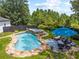 Aerial image of in-ground pool showcasing the rock surround, the pool's waterfall, and patio seating at 269 Red Gate Dr, Canton, GA 30115