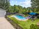 Aerial shot of an in-ground pool featuring a waterfall, spa, stone detail, and patio seating at 269 Red Gate Dr, Canton, GA 30115