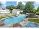 Gorgeous in-ground pool with waterfall feature and nearby poolhouse creating a relaxing outdoor oasis at 269 Red Gate Dr, Canton, GA 30115
